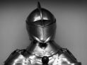 Close-up shot of vintage medieval knight armor in monochrome.